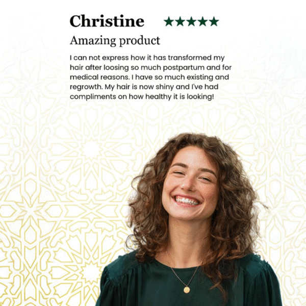A smiling woman with curly brown hair wears a green blouse and gold necklace. She gives Z Secrets a 5 Star Review and testimonial about improved hair health.